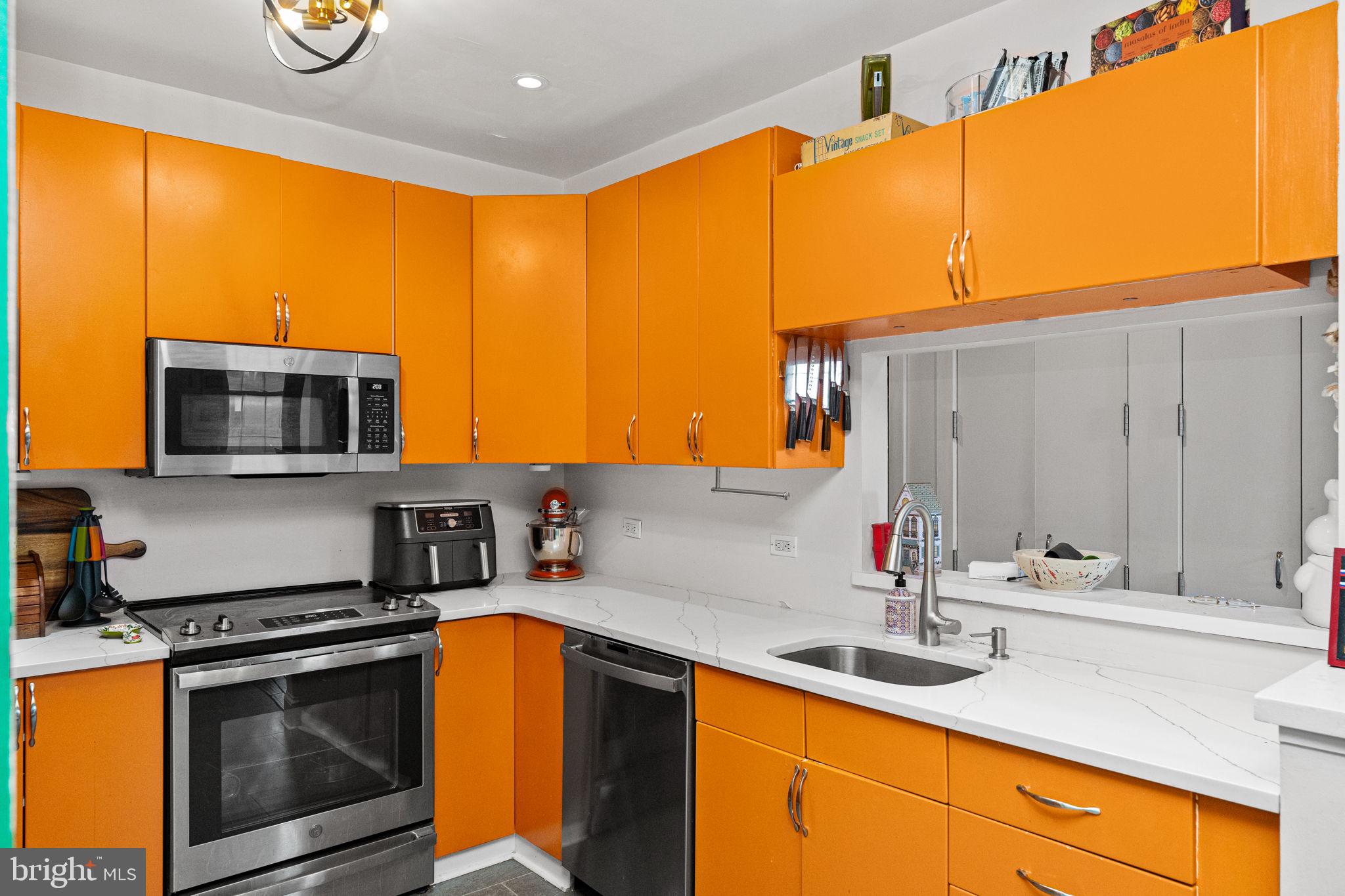 214 New Street, Unit G Philadelphia, PA 19106 - Photo 6 of 17 a kitchen with stainless steel appliances granite countertop a sink a stove and a refrigerator