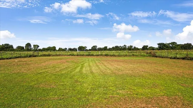 a view of a lake with houses in the back
