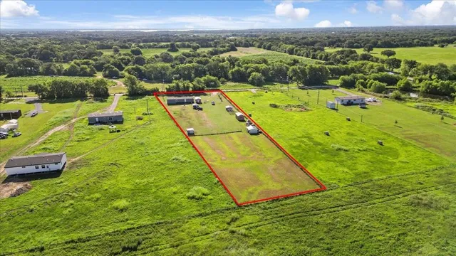 an aerial view of residential houses with outdoor space and swimming pool