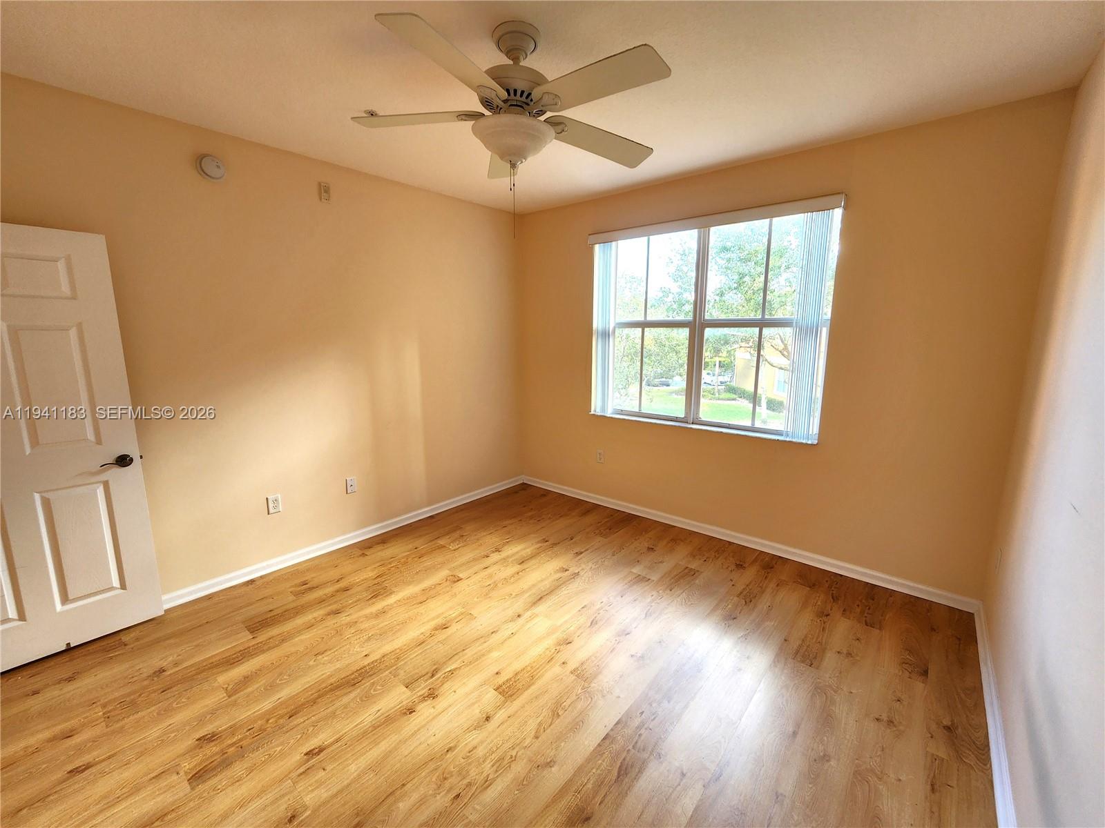 4602 Southwest 160th Avenue, Unit 524 Miramar, FL 33027 - Photo 17 of 33 a view of an empty room with a window and wooden floor