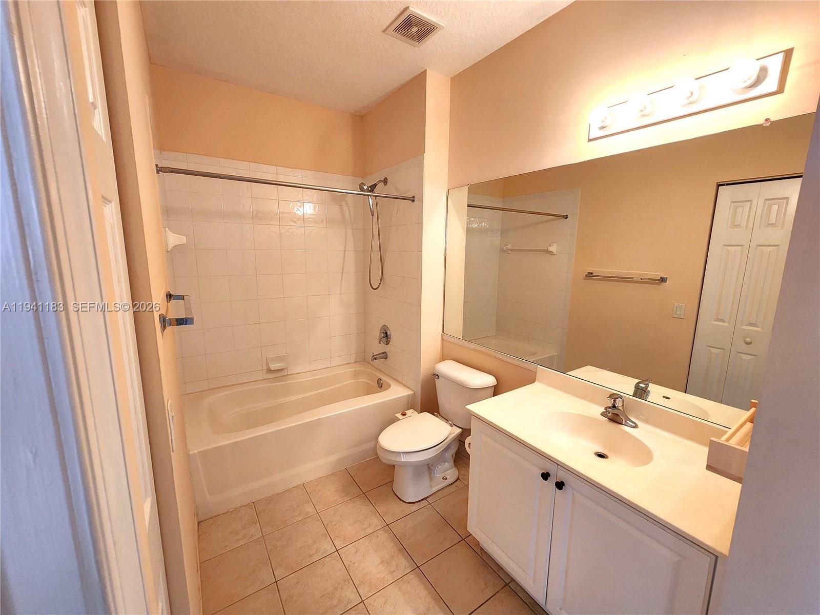 4602 Southwest 160th Avenue, Unit 524 Miramar, FL 33027 - Photo 22 of 33 a bathroom with a double vanity sink toilet mirror and shower