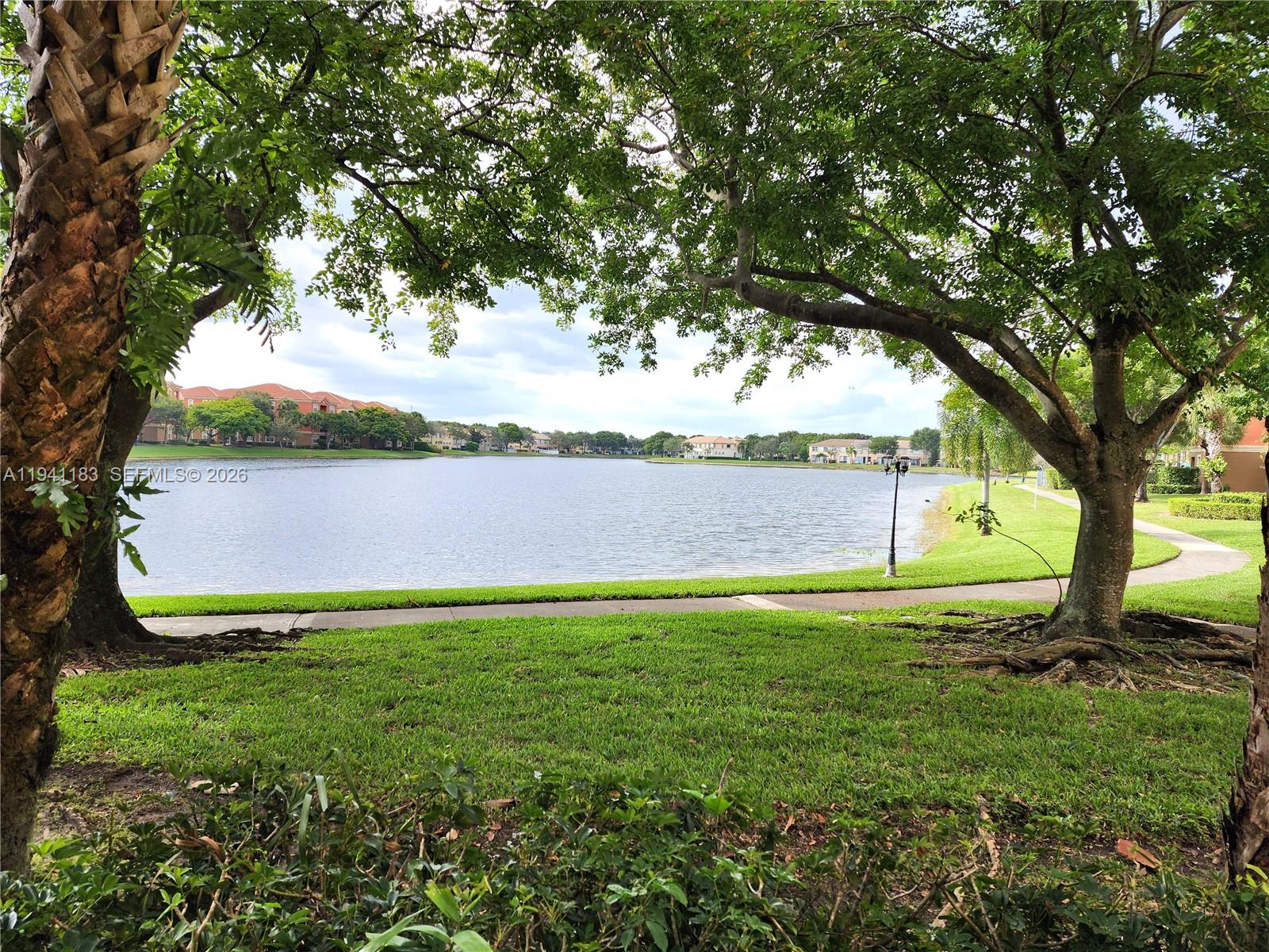 4602 Southwest 160th Avenue, Unit 524 Miramar, FL 33027 - Photo 32 of 33 a view of yard with swimming pool and green space