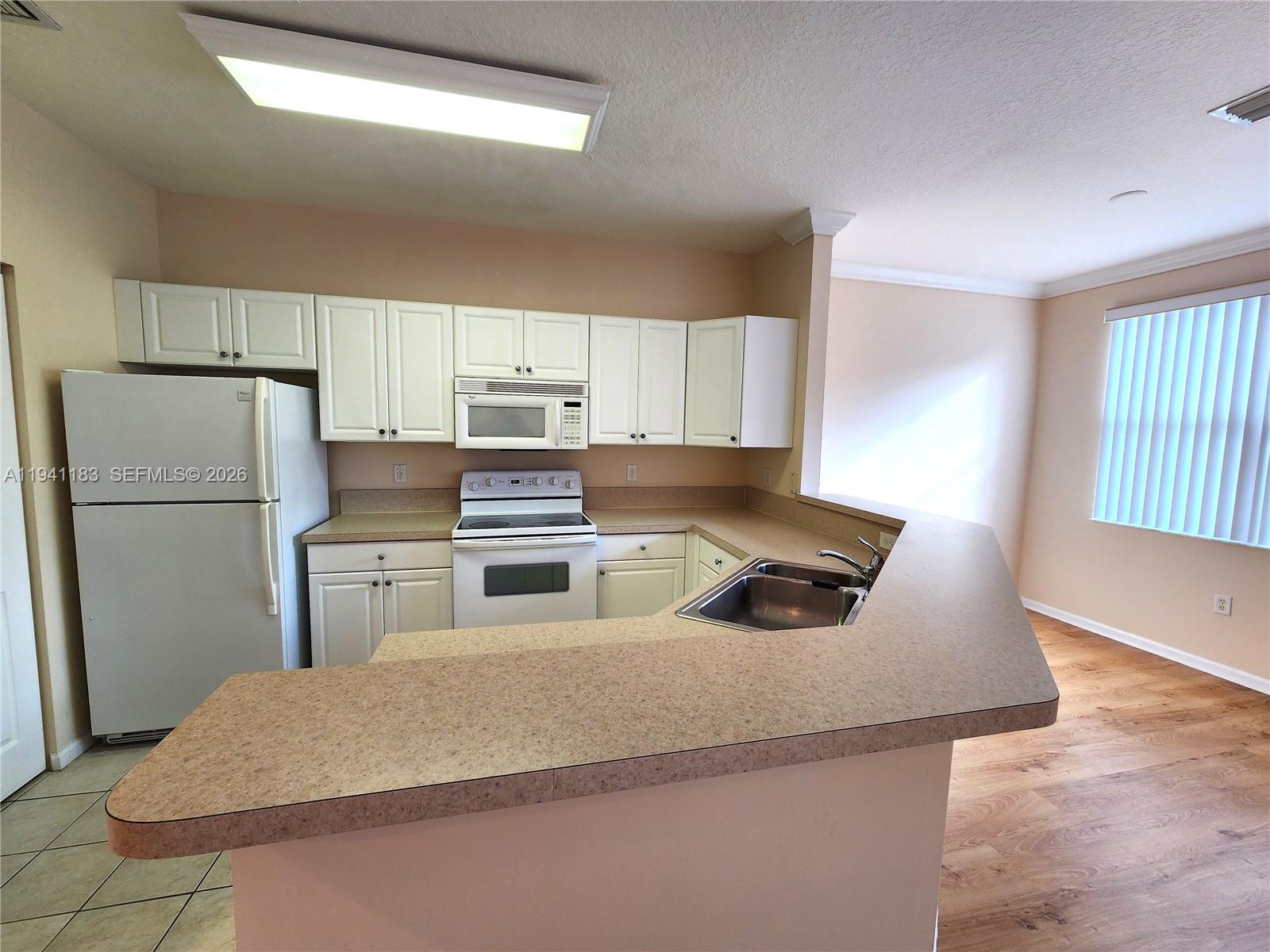 4602 Southwest 160th Avenue, Unit 524 Miramar, FL 33027 - Photo 5 of 33 a kitchen with refrigerator and window