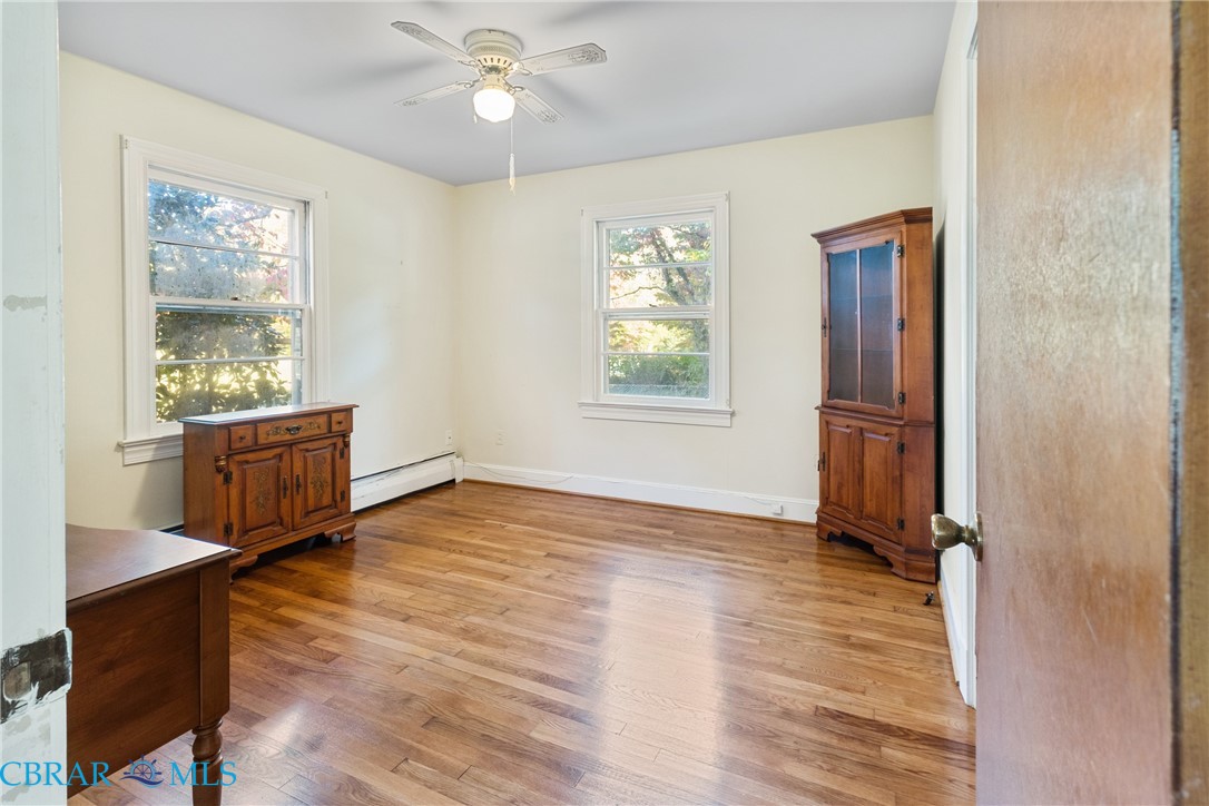 275 Waverly Road Urbanna, VA 23175 - Photo 17 of 27 Empty room with light wood-type flooring, baseboard heating, and a ceiling fan