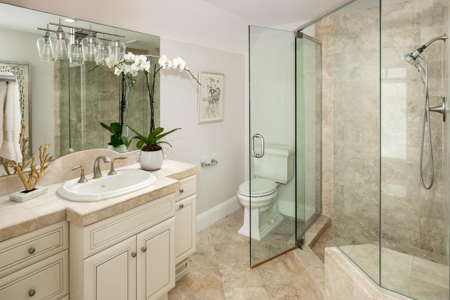 345 Harcross Road Woodside, CA 94062 - Photo 14 of 37 a bathroom with a shower sink and mirror
