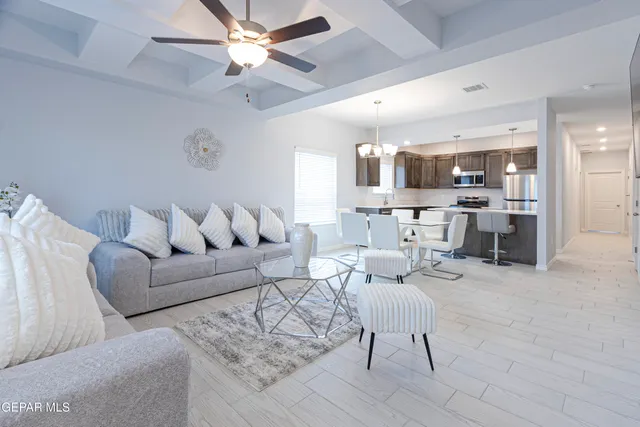 a living room with furniture and a chandelier