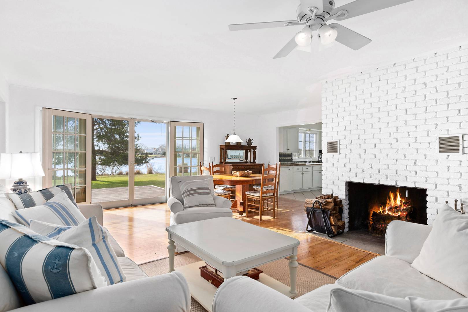 69 Ferry Road Sag Harbor, NY 11963 - Photo 8 of 17 a living room with furniture a fireplace and a floor to ceiling window