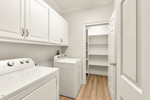 a view of storage and utility room with washer and dryer