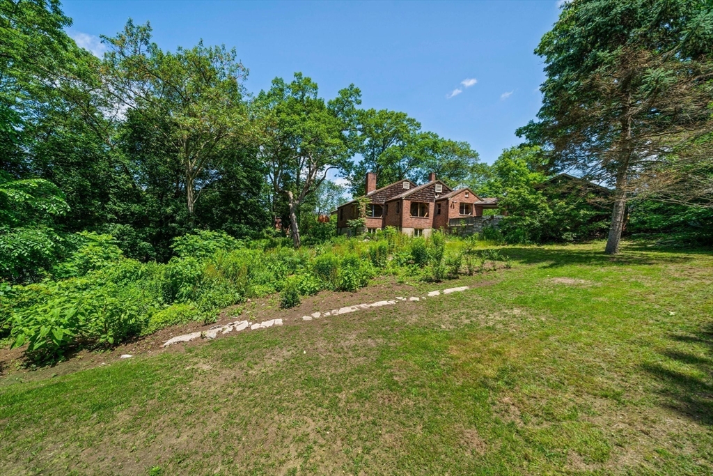 335 Langley Road Newton, MA 02459 - Photo 12 of 15 a house view with a garden space