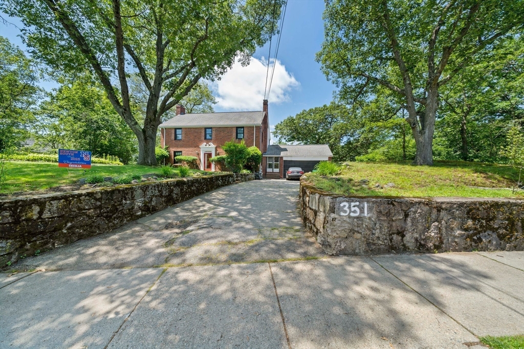 335 Langley Road Newton, MA 02459 - Photo 6 of 15 a view of a house with a yard and sitting area