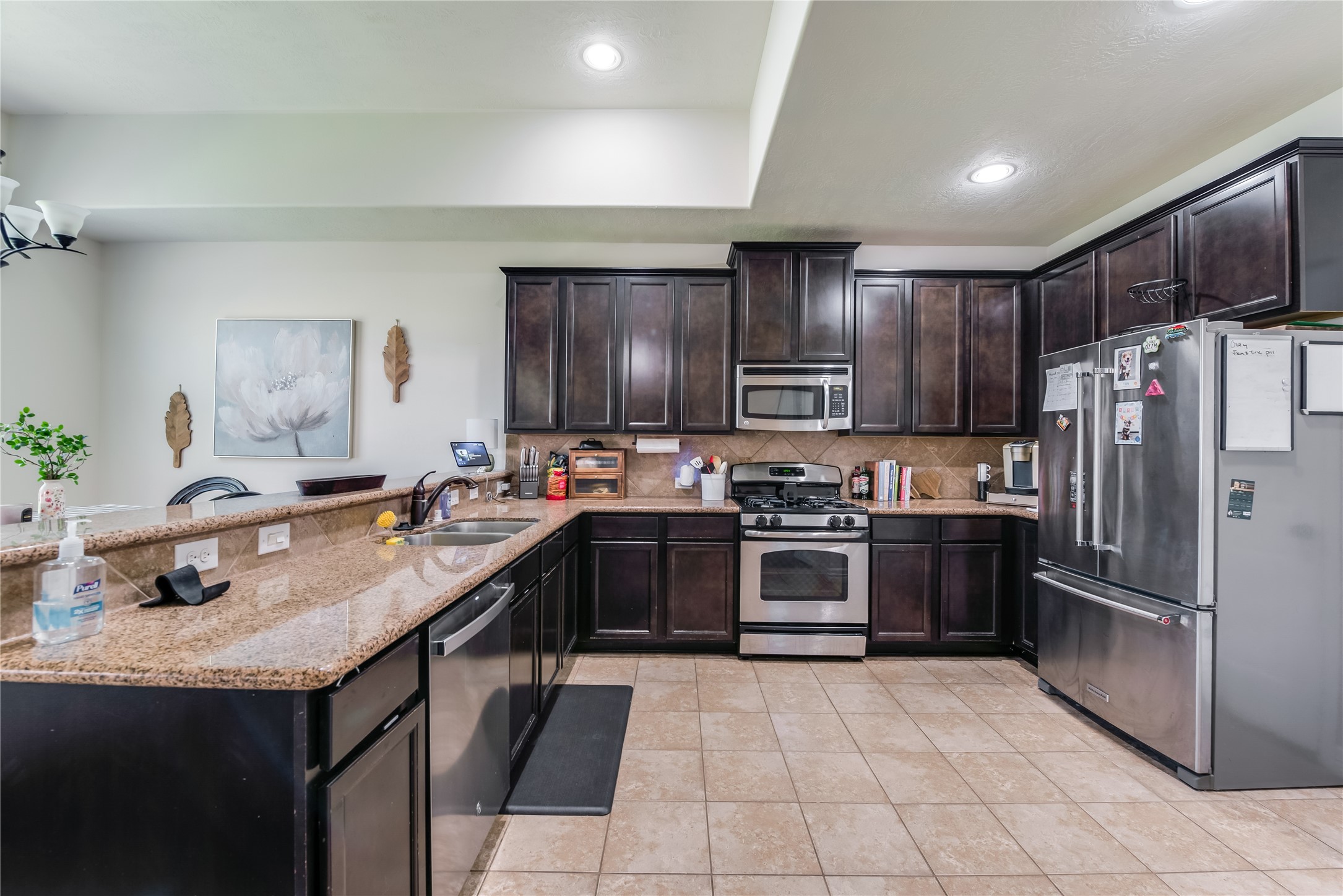 25118 Andris Lane Spring, TX 77386 - Photo 13 of 42 a kitchen with granite countertop a refrigerator stove top oven and sink
