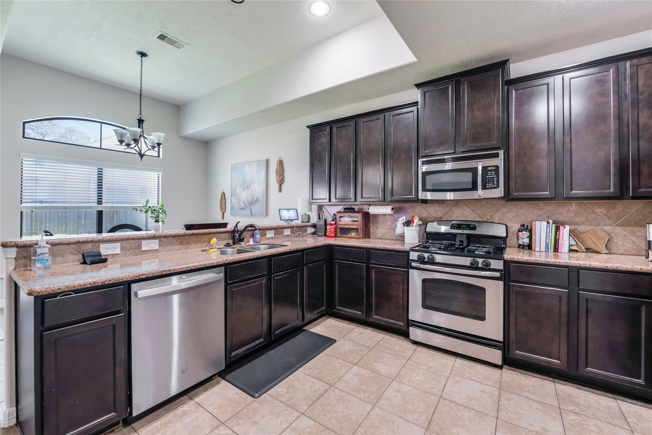 25118 Andris Lane Spring, TX 77386 - Photo 14 of 42 a kitchen with kitchen island granite countertop stainless steel appliances and sink