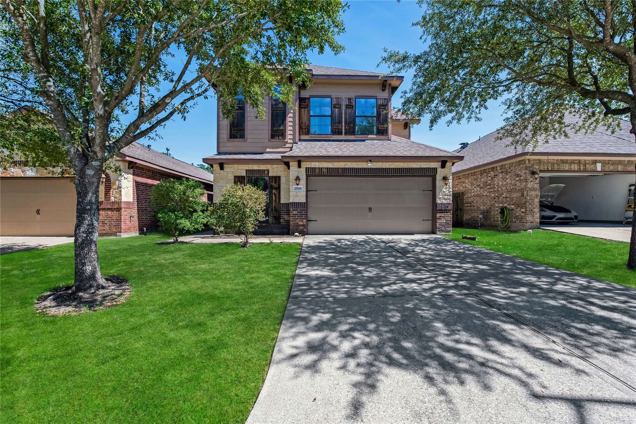 25118 Andris Lane Spring, TX 77386 - Photo 2 of 42 a front view of a house with a garden and yard