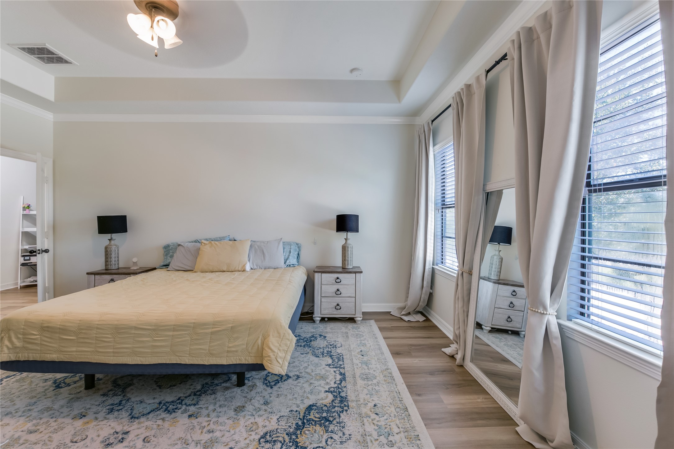 25118 Andris Lane Spring, TX 77386 - Photo 21 of 42 a bedroom with a bed and a large mirror next to a window