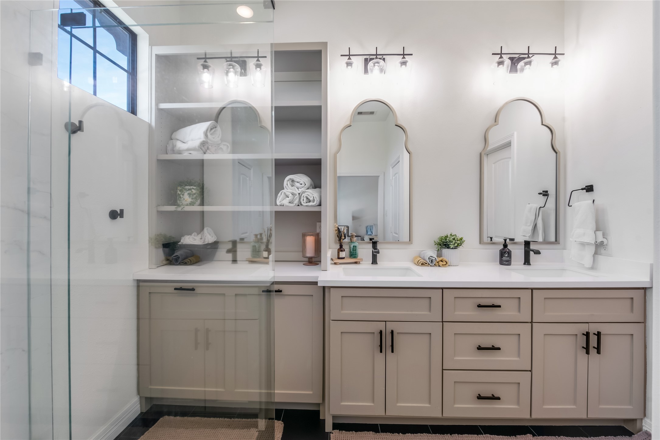 25118 Andris Lane Spring, TX 77386 - Photo 24 of 42 a bathroom with double vanity sinks a mirror a glass door a shower and a mirror