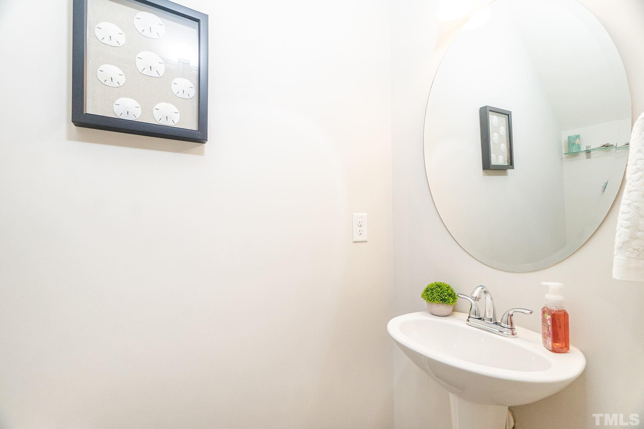 219 Torpoint Road Durham, NC 27703 - Photo 12 of 43 a bathroom with a sink and mirror