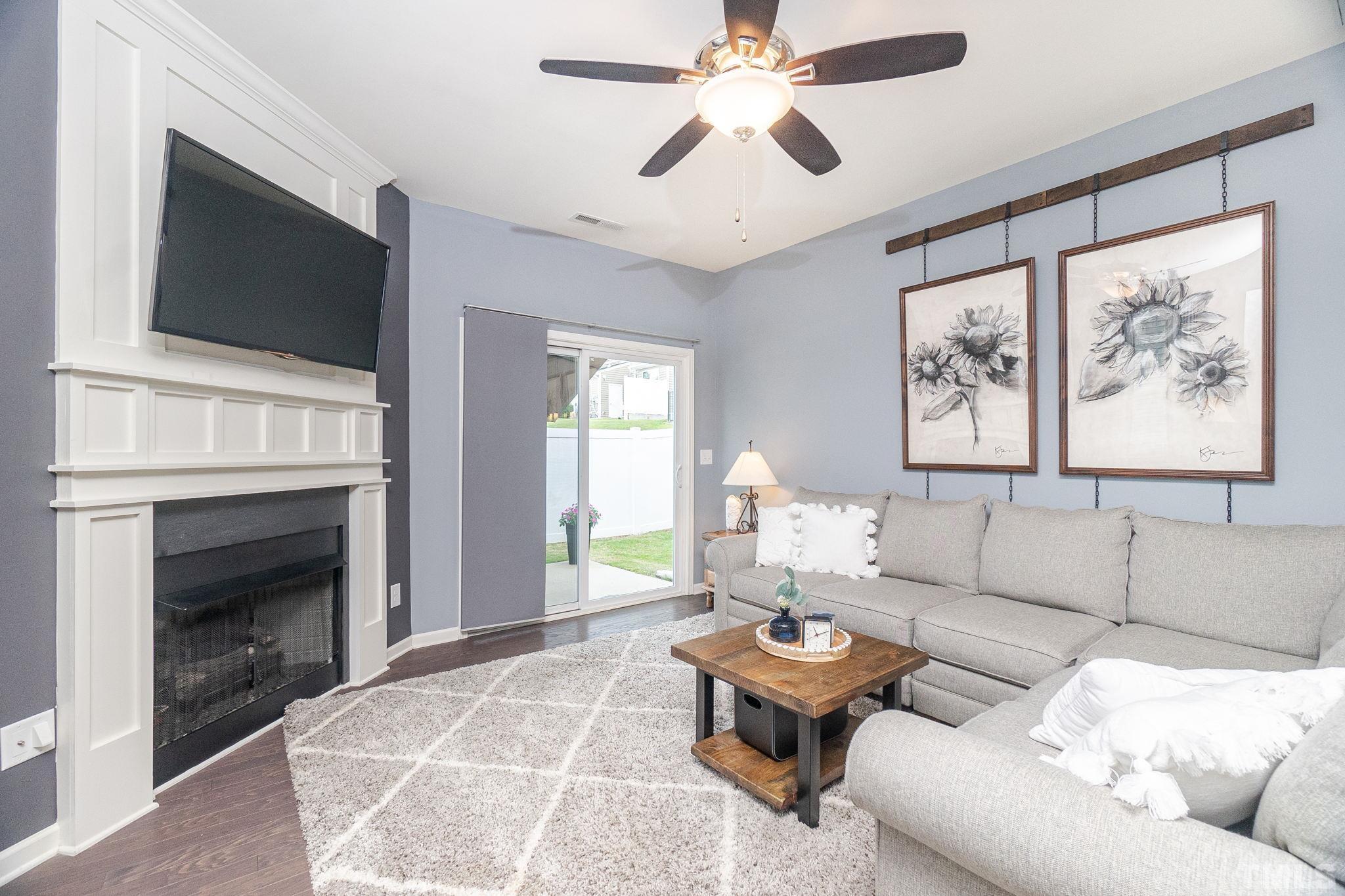 219 Torpoint Road Durham, NC 27703 - Photo 16 of 43 a living room with furniture a fireplace and a flat screen tv