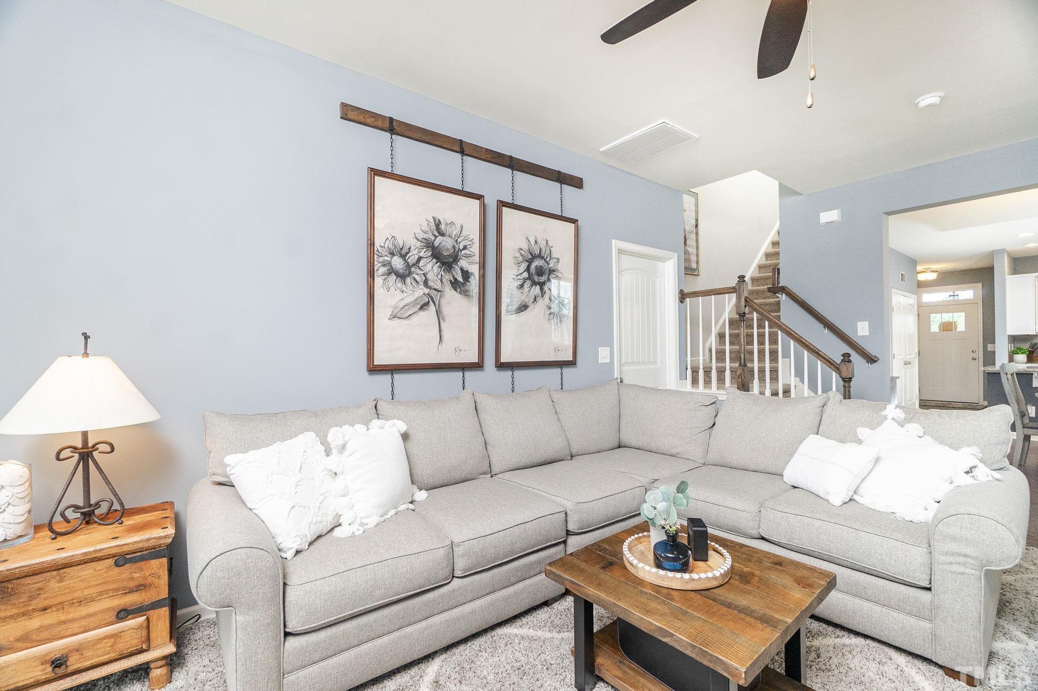 219 Torpoint Road Durham, NC 27703 - Photo 20 of 43 a living room with furniture and a painting on the wall