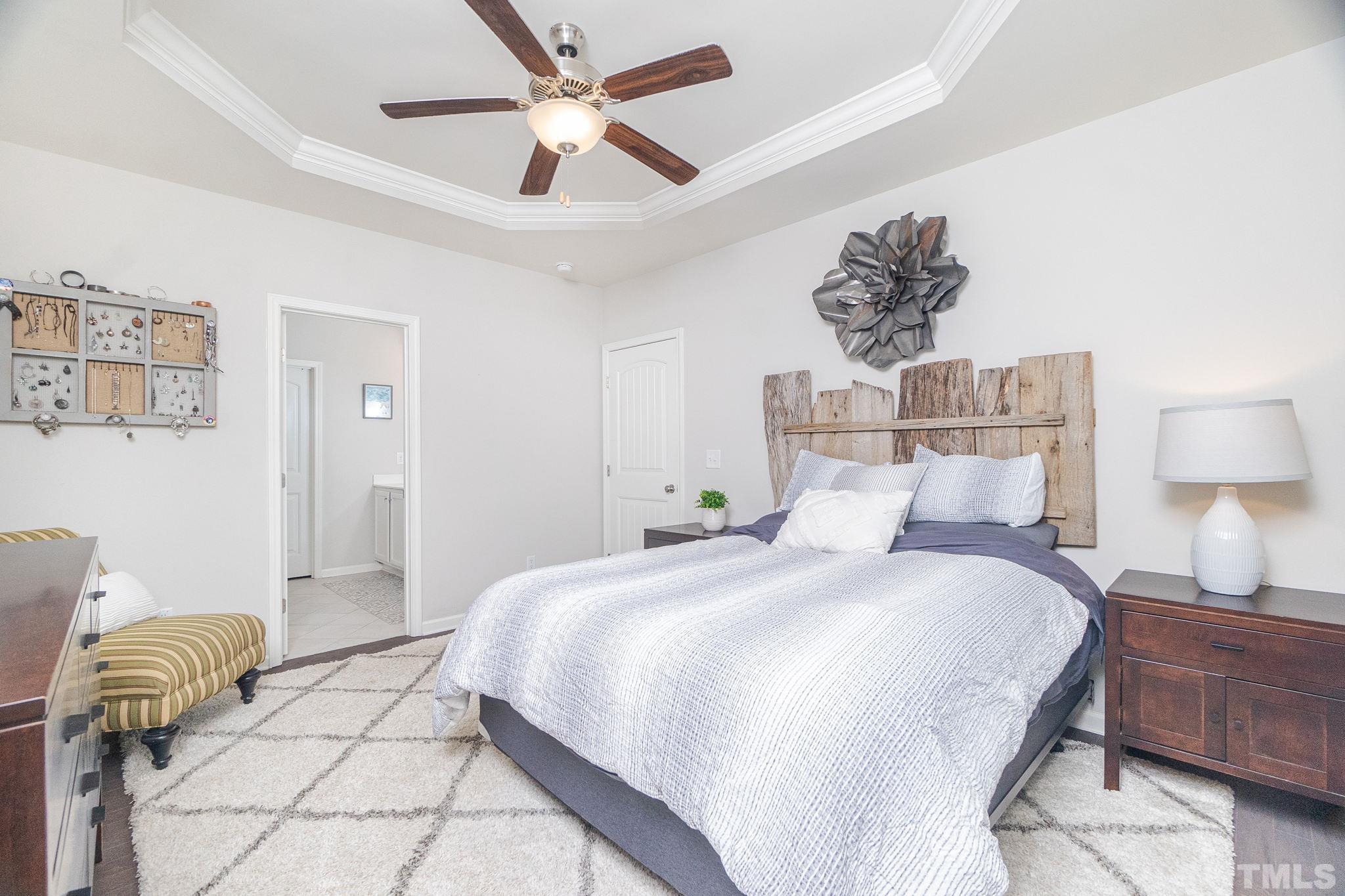 219 Torpoint Road Durham, NC 27703 - Photo 22 of 43 a bedroom with a bed and a chandelier