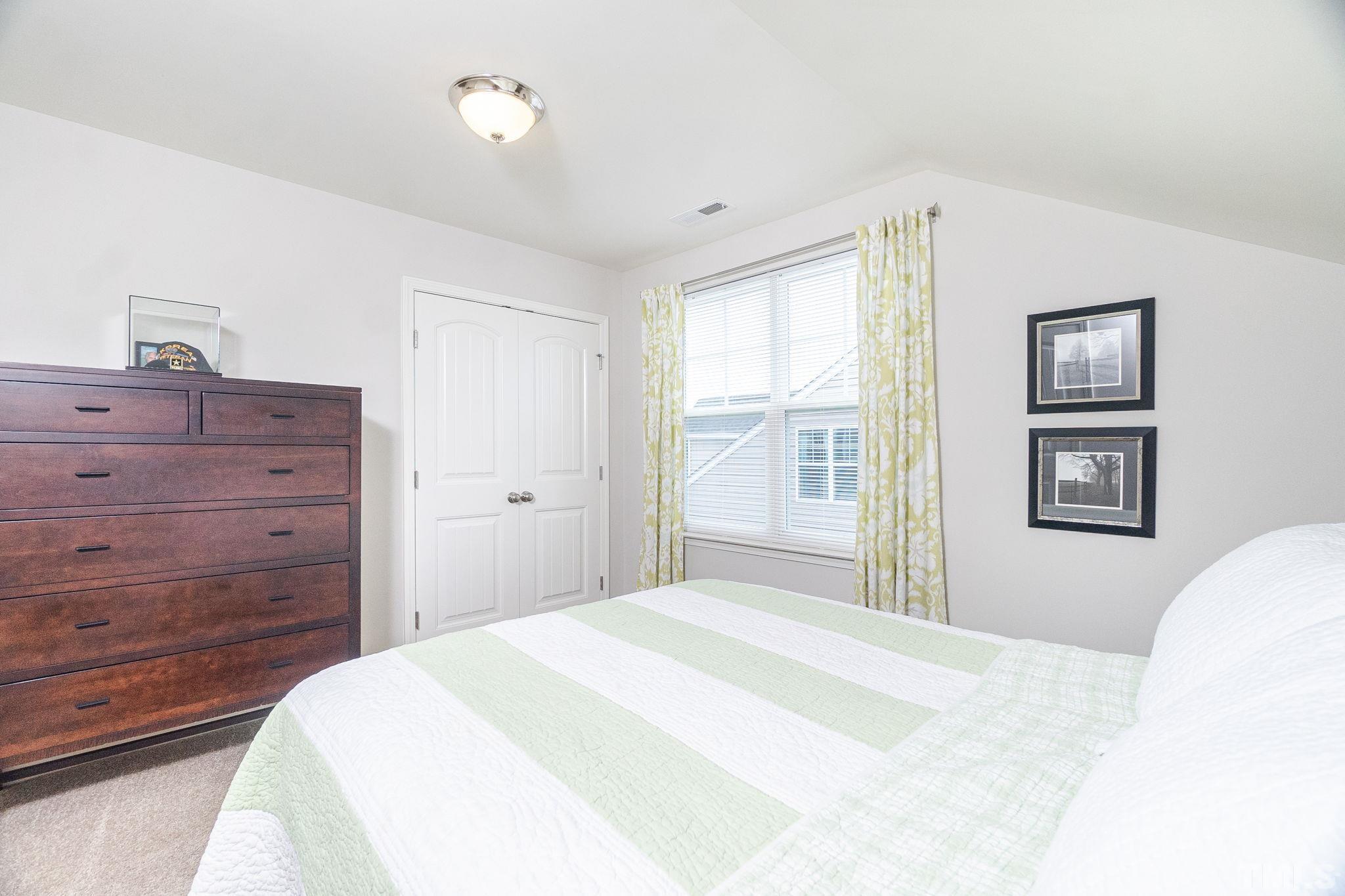 219 Torpoint Road Durham, NC 27703 - Photo 29 of 43 a bedroom with a bed and a window