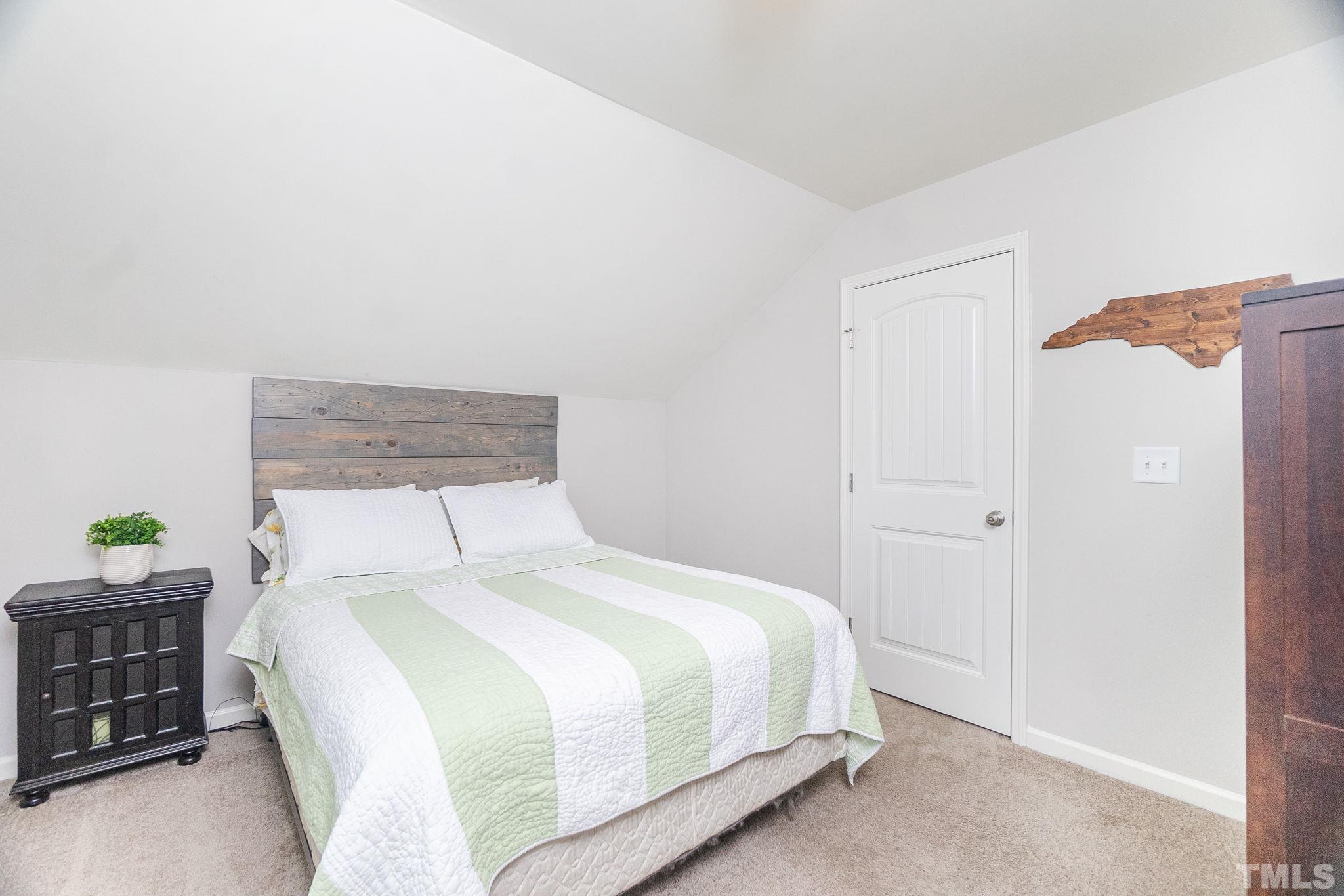 219 Torpoint Road Durham, NC 27703 - Photo 30 of 43 a bedroom with a bed and a window