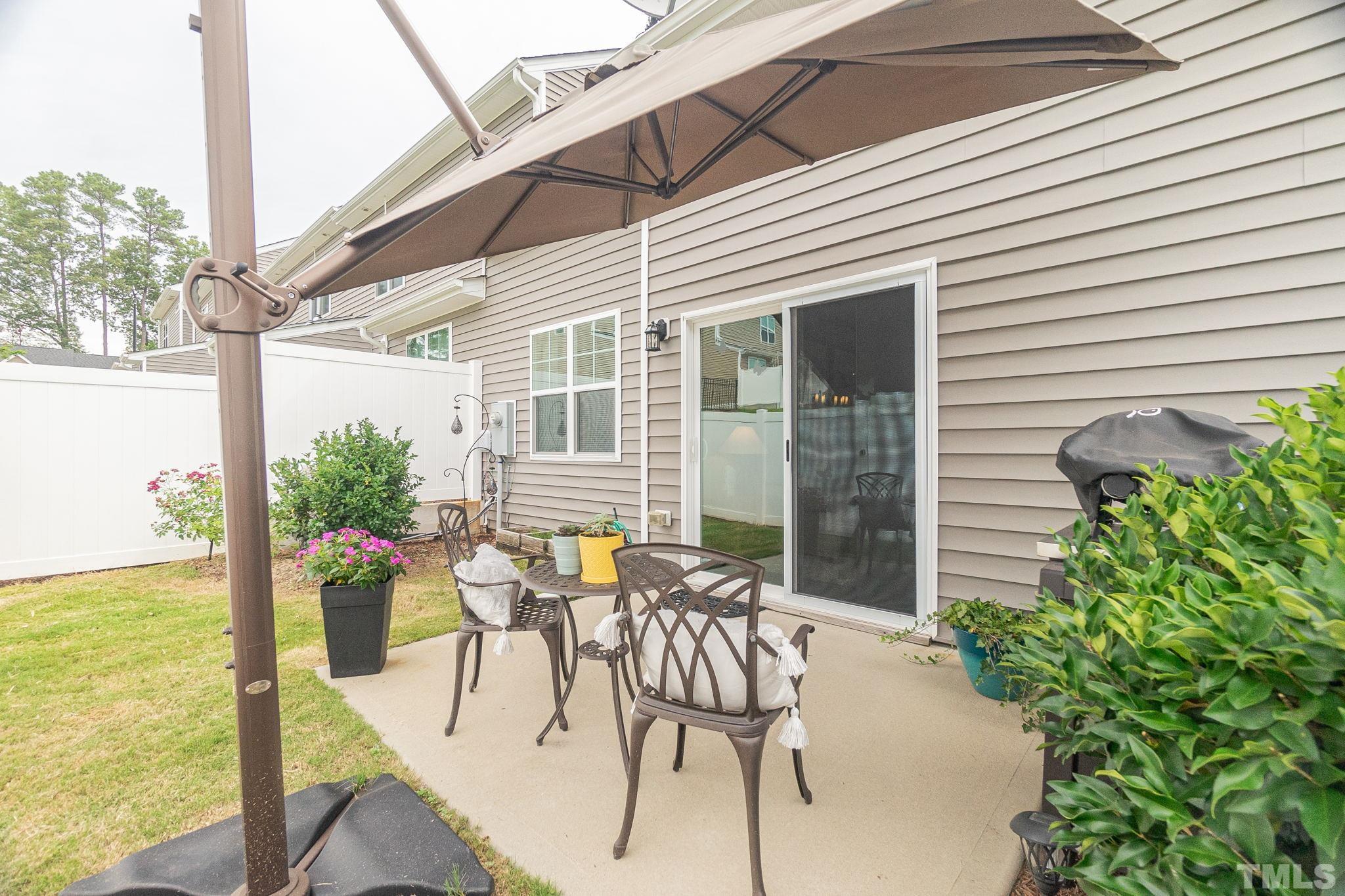 219 Torpoint Road Durham, NC 27703 - Photo 38 of 43 a view of a patio with table and chairs and potted plants