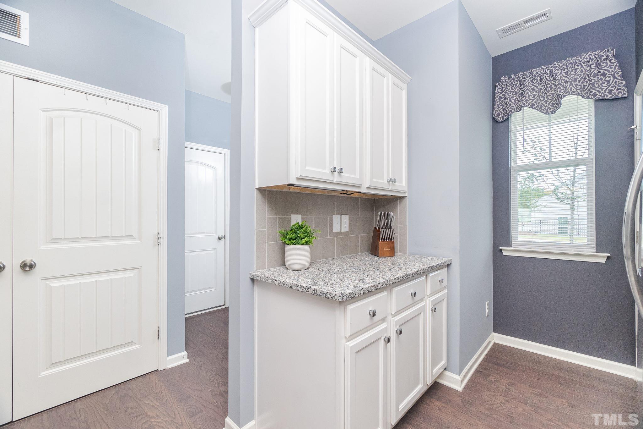 219 Torpoint Road Durham, NC 27703 - Photo 6 of 43 a kitchen with stainless steel appliances granite countertop a sink and a cabinets with wooden floor