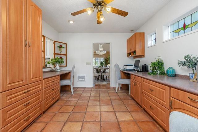 a large kitchen with stainless steel appliances a counter space a sink and a window