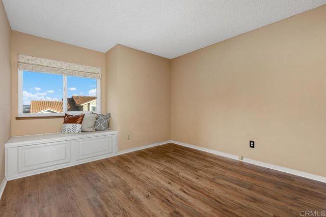 a view of a small space with wooden floor and a window