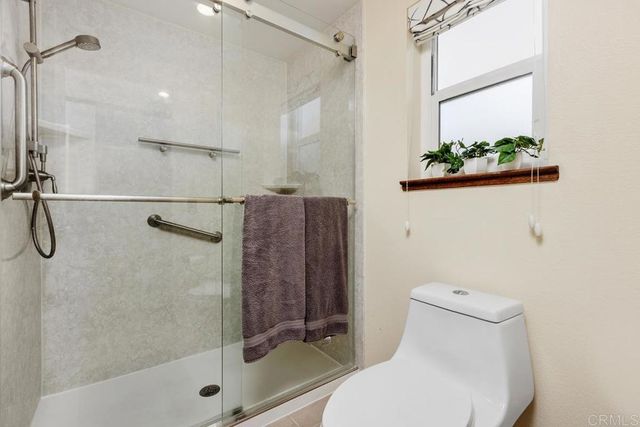 a bathroom with a toilet and a shower