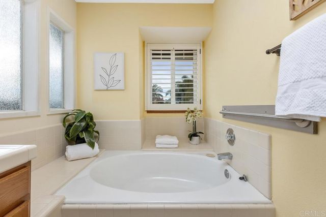 a white bath tub sitting next to a window