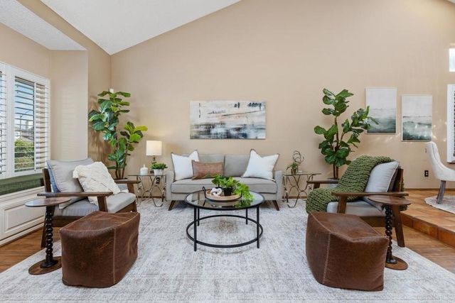 a living room with furniture potted plant and a window