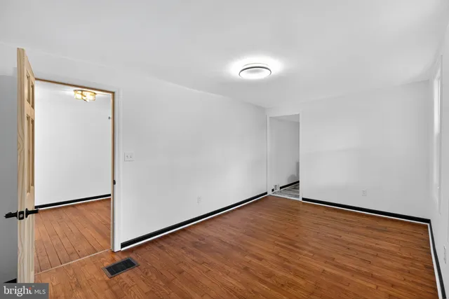 an empty room with wooden floor