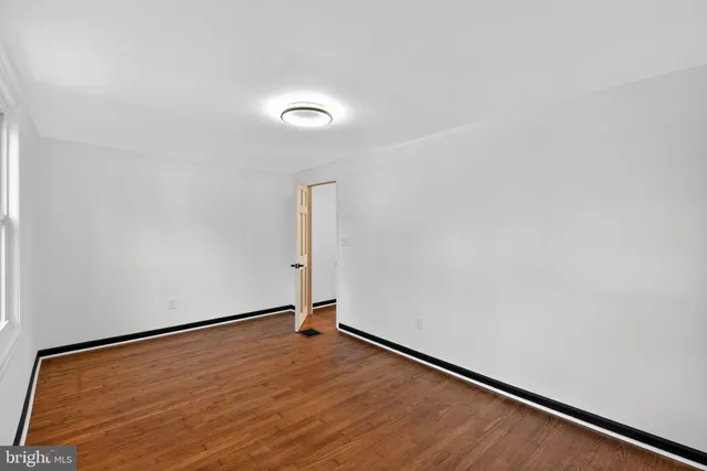 an empty room with wooden floor