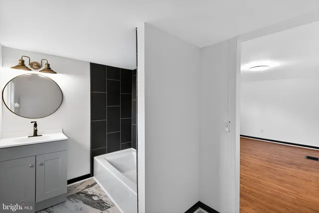 a bathroom with a sink toilet and tub