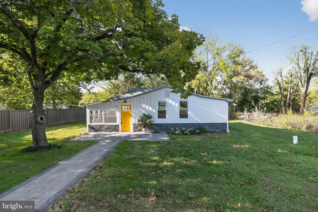 a house view with a sitting space and garden