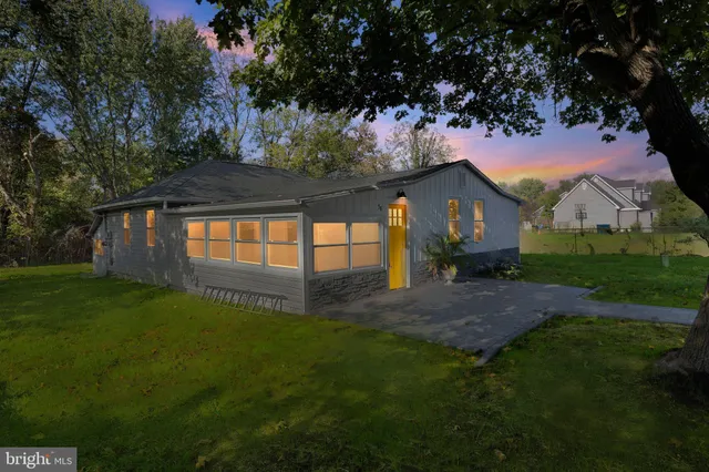 a view of backyard of house with green space