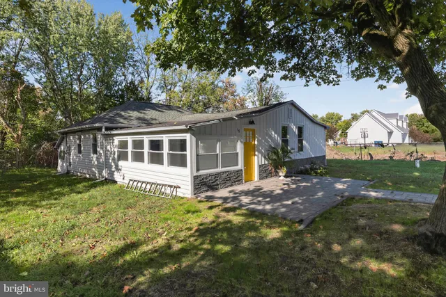 a view of a house with a tree in the yard