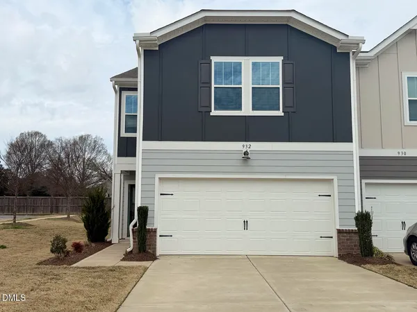 a front view of a house with garage