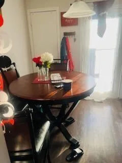 a view of a dining room with furniture and a chandelier