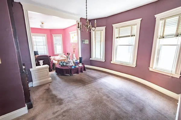 a living room with furniture and floor to ceiling windows