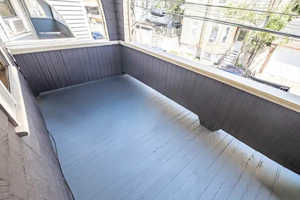 a view of balcony with wooden floor