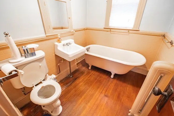a bathroom with a sink mirror vanity and toilet