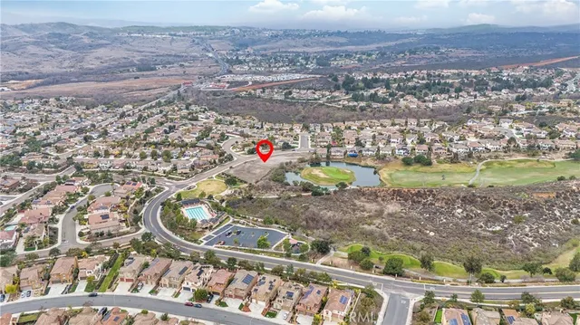 an aerial view of a houses with a yard and lake view
