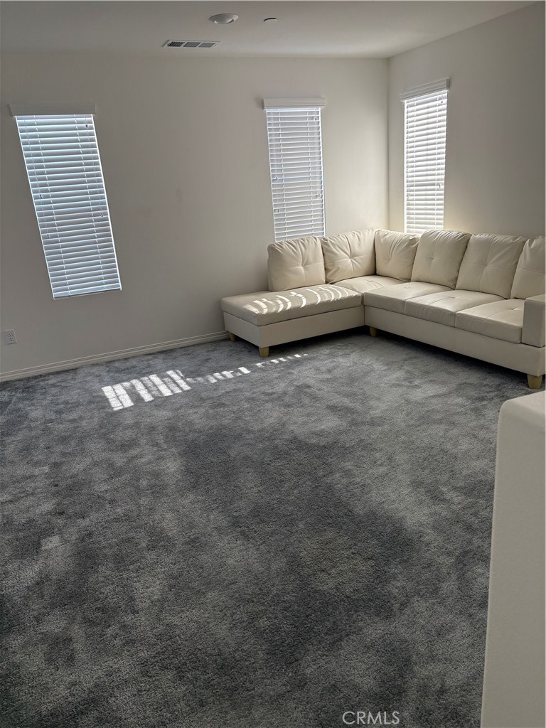 2544 Gunner Ridge Way Rialto, CA 92377 - Photo 18 of 22 a living room with furniture and a window