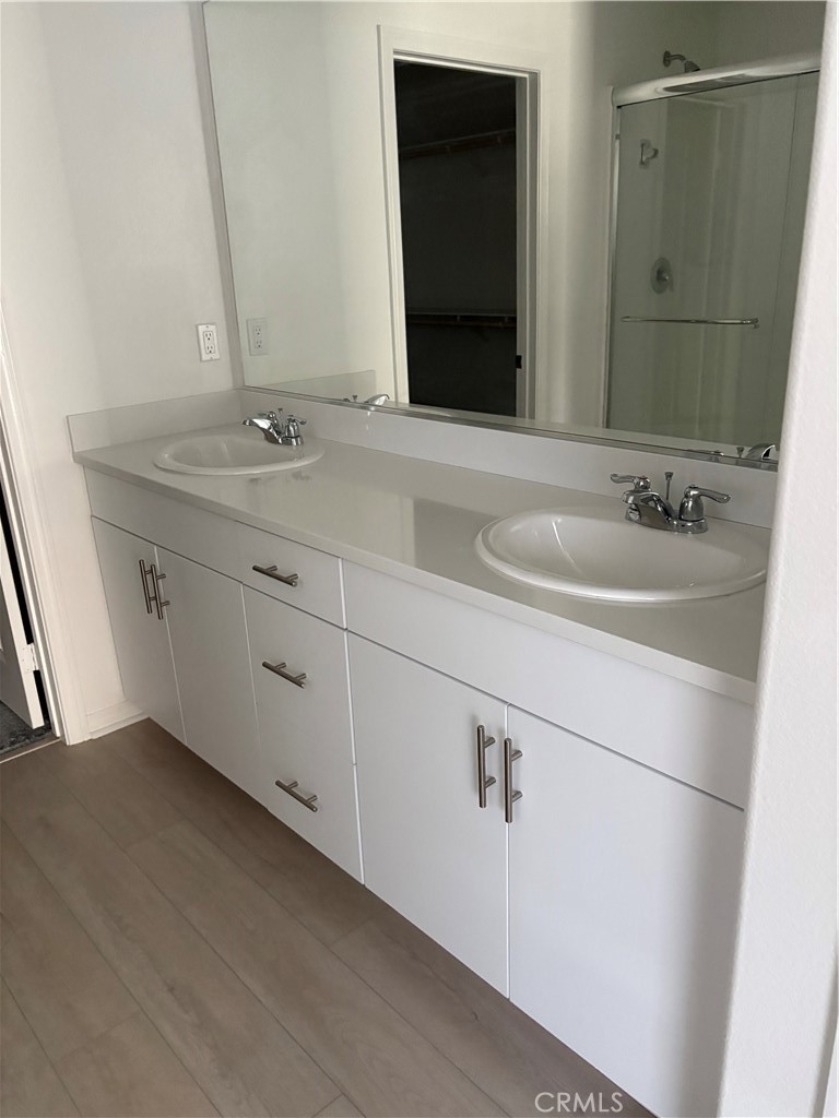 2544 Gunner Ridge Way Rialto, CA 92377 - Photo 19 of 22 a bathroom with a double vanity sink and mirror