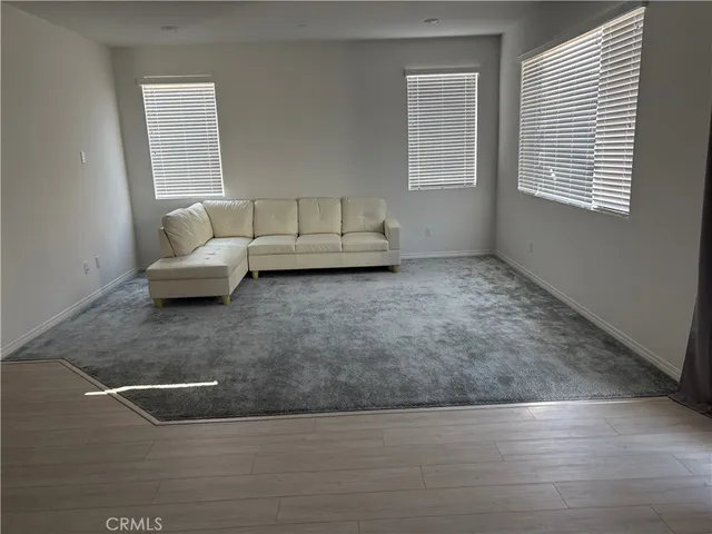 a kitchen with stainless steel appliances granite countertop a stove a refrigerator a sink a microwave and island