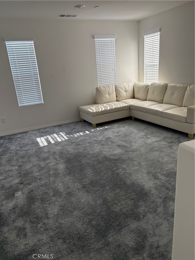 2544 Gunner Ridge Way Rialto, CA 92377 - Photo 3 of 22 a living room with furniture and a window