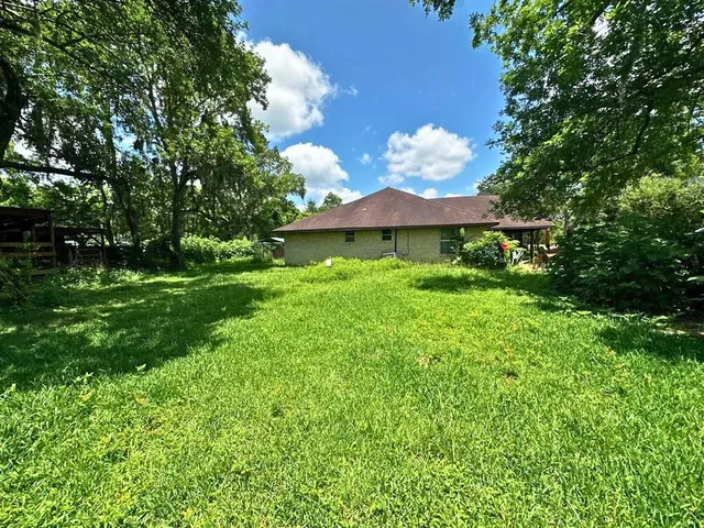 a view of backyard of a house with green space