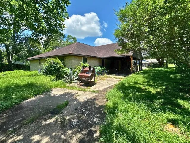 a view of a house with backyard porch and sitting area